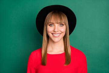 Portrait of young attractive lovely pretty smiling positive girl in black hipster hat isolated on green color background