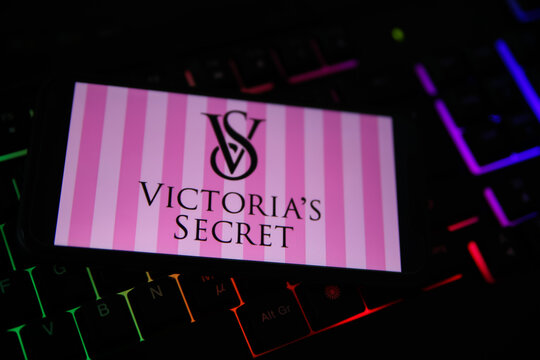 Viersen, Germany - February 9. 2021: Closeup of smartphone screen with logo lettering of victoria s secret on blurred computer keyboard