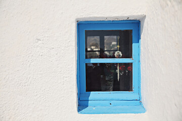 A blue window on a white wall