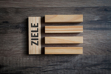Cubes, dice or blocks with the german word for goal or target - Ziele wooden background