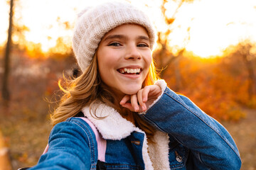 Image of young happy girl outdoors in autumn park