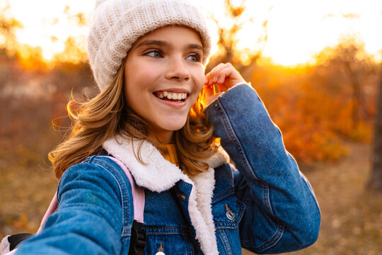 Image of young happy girl outdoors in autumn park