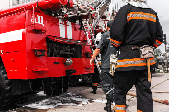  red fire truck with a ladder at sunset.