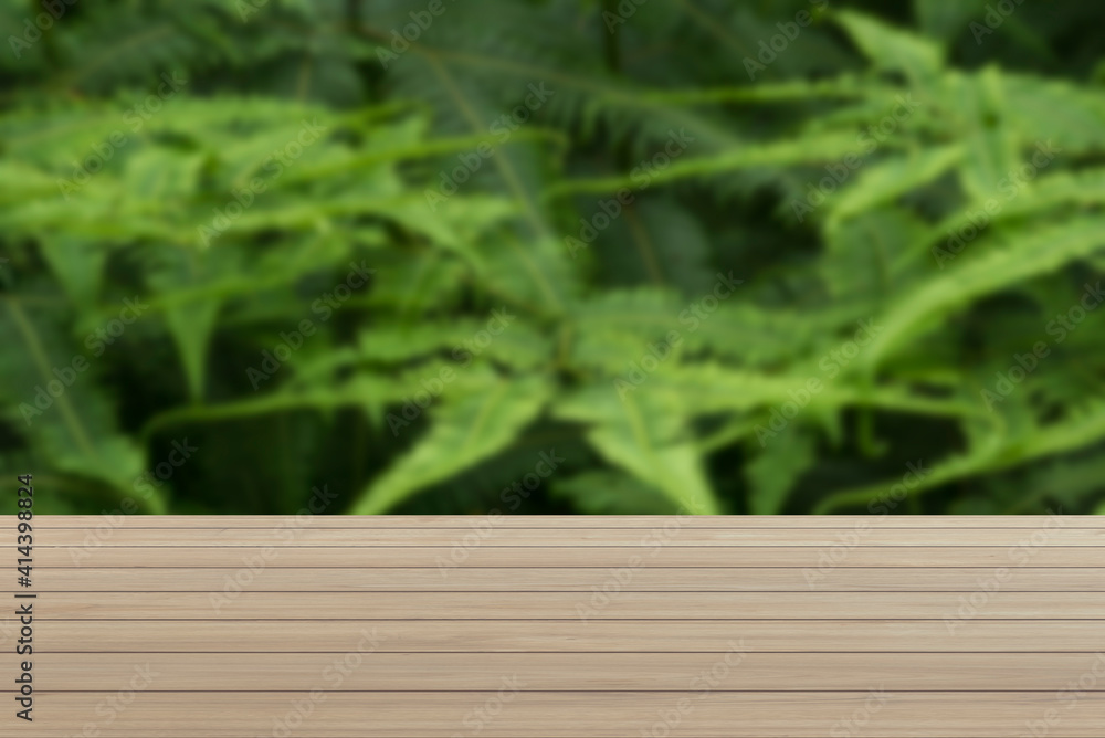 Poster Textures on an empty wooden table and a blurred green backyard. Can be used as a background for presenting products.