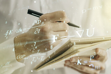 Creative scientific formula concept with man hand writing in notebook on background. Multiexposure