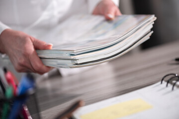Female hands holding magazines