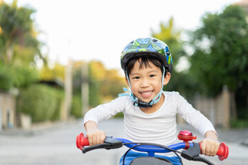 boy is riding bicycle at the park.