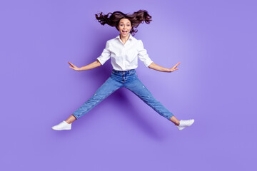 Photo of crazy funny lady jump open mouth wear white shirt jeans sneakers isolated purple color background