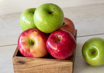 green and red apples box on a white background