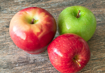 Red and green apples on the wooden table
