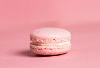 Pink homemade macarons on a pink  background