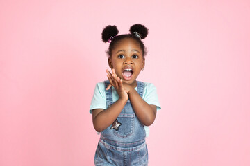 Children, emotions, gestures concept. Close up studio shot of pretty cute little African girl,...