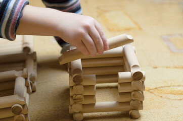 Child plays with a wooden construction set