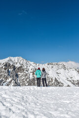 Fototapeta na wymiar Winter hikers on alps trekking on snow