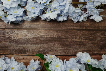 Top view Blooming Flowers frame with copy space on wooden background