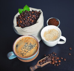 Delicious fresh coffee. Coffee cups, roasted coffee beans in canvas sack and ground powder.