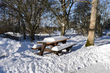 Snow covered furniture by a resting place