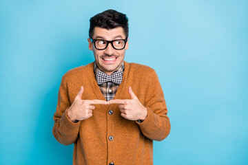 Photo of shy attractive young man touch fingers look empty space dream isolated on pastel blue color background