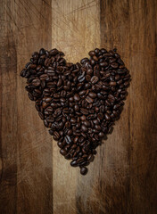 Coffee bean heart on wooden texture