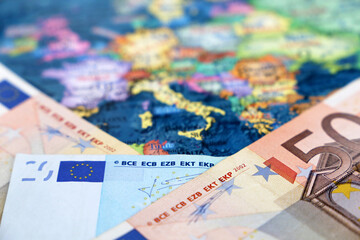 Euro banknotes on the Europe map. Concept of Eurozone, European economy, stock market in EU