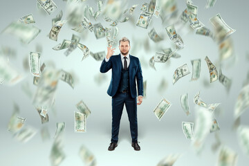 A man in a business suit tosses dollars up, it rains money. Business concept, bookmaker, sports betting, investment, passive income.