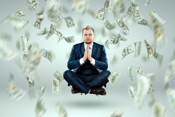 A man in a business suit levitates in the lotus position against the background of falling dollars, rain of money. Business concept, bookmaker, sports betting, investment, passive income.