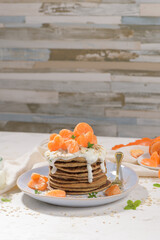 Pancakes with yogurt and tangerines