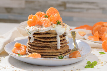 Pancakes with yogurt and tangerines