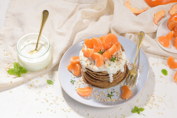 Pancakes with yogurt and tangerines