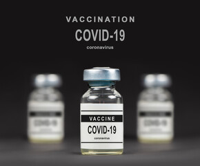 Covid-19 vaccine on a laboratory bench. to fight the coronavirus sars-cov-2 pandemic. Dark bacground