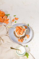 Pancakes with yogurt and tangerines