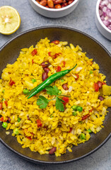 spicy Indian snack or breakfast  poha with onion and peanuts