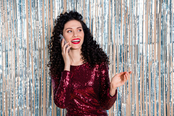Portrait of gorgeous curly hairstyle cheerful lady speak phone hand explain isolated on decorated...