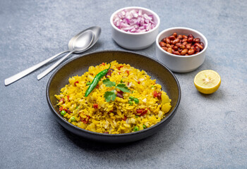 spicy Indian snack or breakfast  poha with onion and peanuts