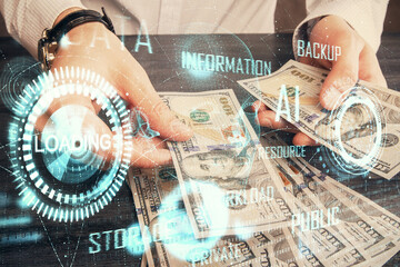 Double exposure of technology drawing hologram and us dollars bills and man hands. Data concept