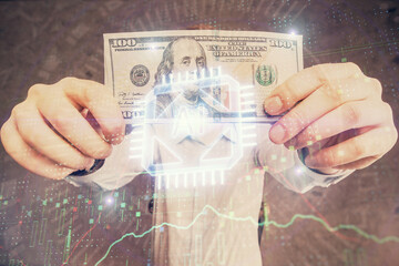Double exposure of technology drawing hologram and us dollars bills and man hands. Data concept