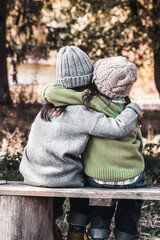 Two happy girls as friends hug each other. Little girlfriends in park. Children Friendship. - 414419079