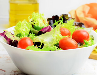Mixed salad, accompanied by small tomatoes. 