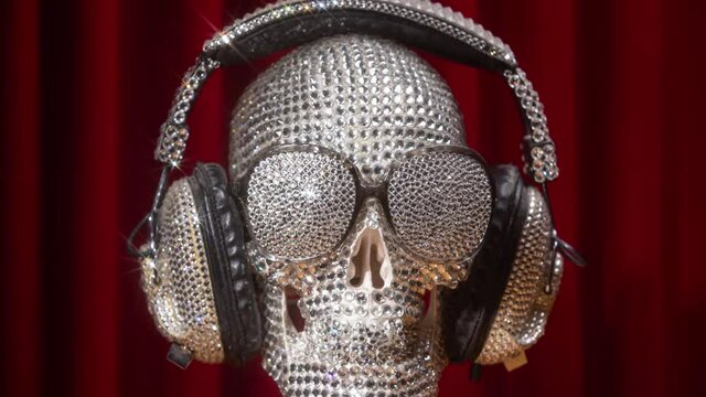 Diamond covered skull with headphones and sunglasses rotating