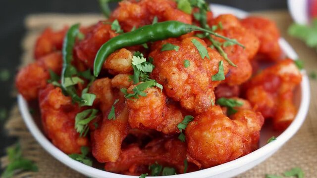 Gobi Manchurian dry, Gobi 65 popular Indian street food snack Delhi Mumbai India made cauliflower florets Veg Manchurian chilly gobi 4K slow motion footage video Indo Chinese side dish chapati roti 