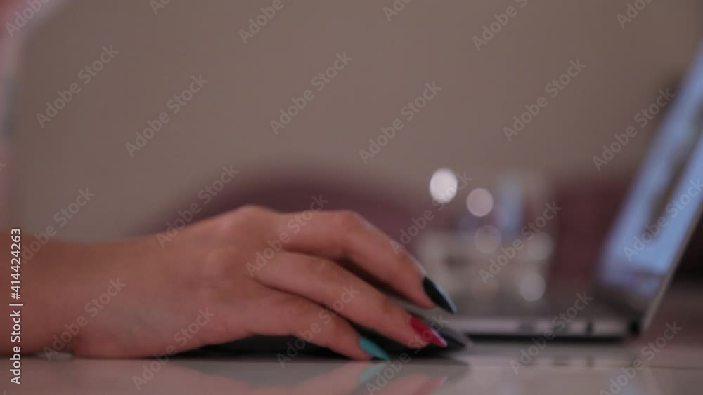 Poster working woman using computer laptop, hand touching control wireless mouse. multi color nail polished