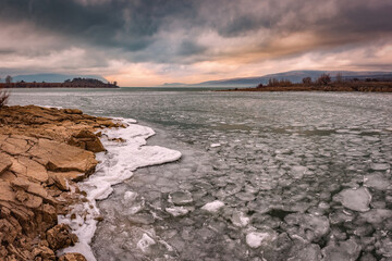 landscape with a frozen lake and sunset