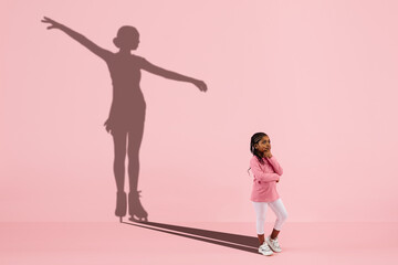 Childhood and dream about big and famous future. Conceptual image with girl and drawned shadow of...