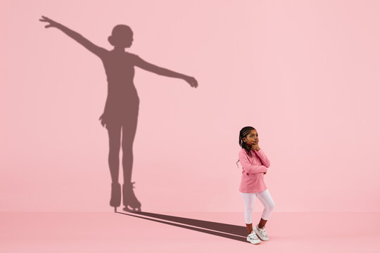 Childhood and dream about big and famous future. Conceptual image with girl and drawned shadow of female figure skater on coral pink background. Childhood, dreams, imagination, education concept.