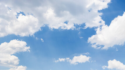 Naklejka na ściany i meble Beautiful white fluffy clouds on a blue sky background