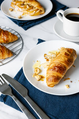 Morning coffee with croissants stuffed with caramelized pear, hazelnuts, and ricotta.