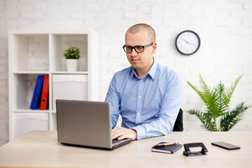 Fototapeta premium young man using computer in the office or at home
