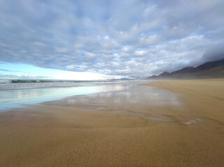 Cofete beach, amazing reflects and cloudy sky
