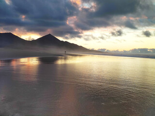 Cofete beach beautiful sunset with a colorful sky and the reflects on the water. Fuerteventura, Canary island, Spain.