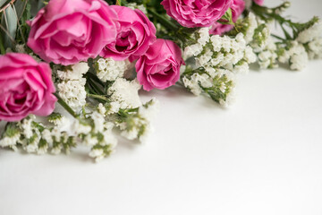white dried flowers statice and rose raspberry peony on a white background . space for text